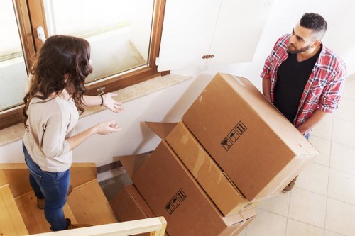 Removal team handling boxes and furniture during a Leyton home move