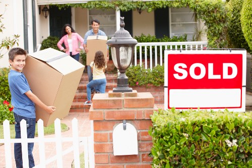 Professional movers unloading household items at a Leyton property
